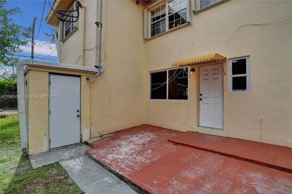 a backyard of a house with outdoor seating