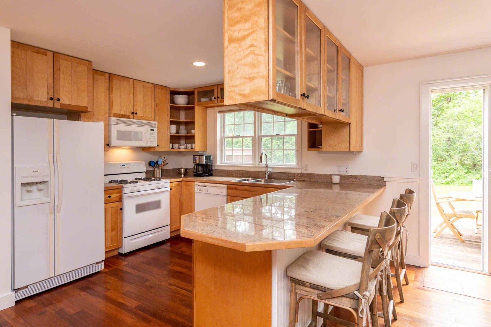 29 Pradas Way Edgartown, MA 02539 - Photo 11 of 30 a kitchen with granite countertop wooden floors and white appliances