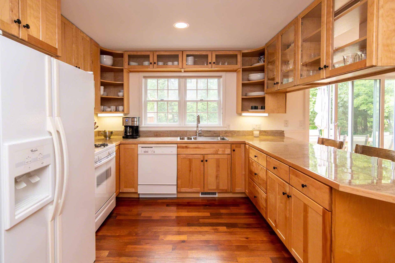 29 Pradas Way Edgartown, MA 02539 - Photo 12 of 30 a kitchen with granite countertop a refrigerator a sink dishwasher and white cabinets with wooden floor