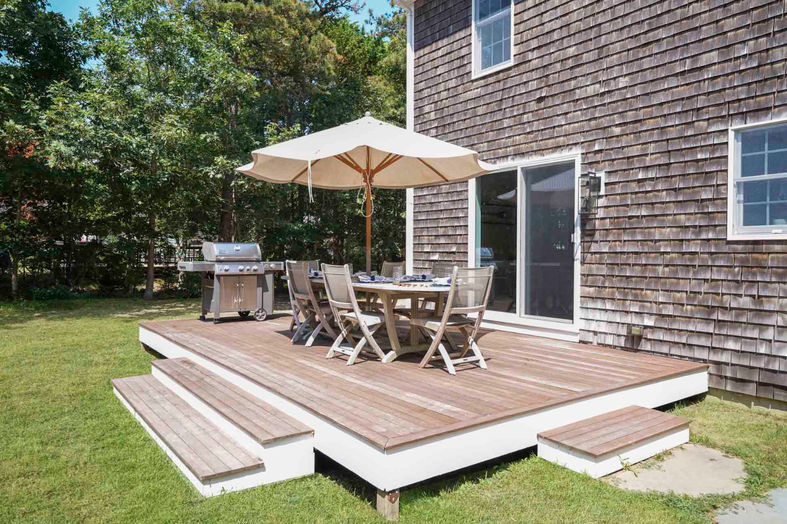 29 Pradas Way Edgartown, MA 02539 - Photo 25 of 30 a view of a patio with table and chairs under an umbrella