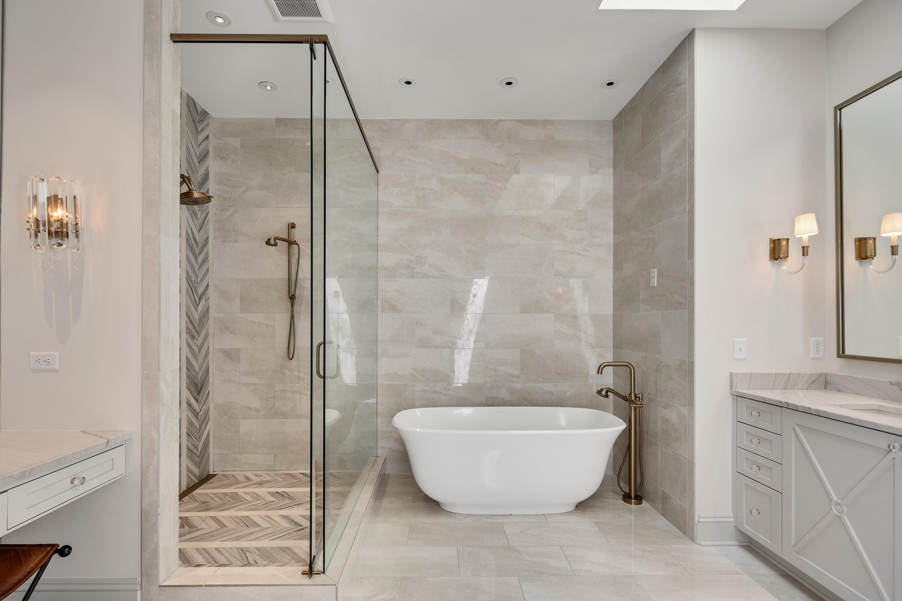 165 Waring Road Memphis, TN 38117 - Photo 19 of 40 Full bath featuring vanity, a soaking tub, a stall shower, tile walls, and a skylight