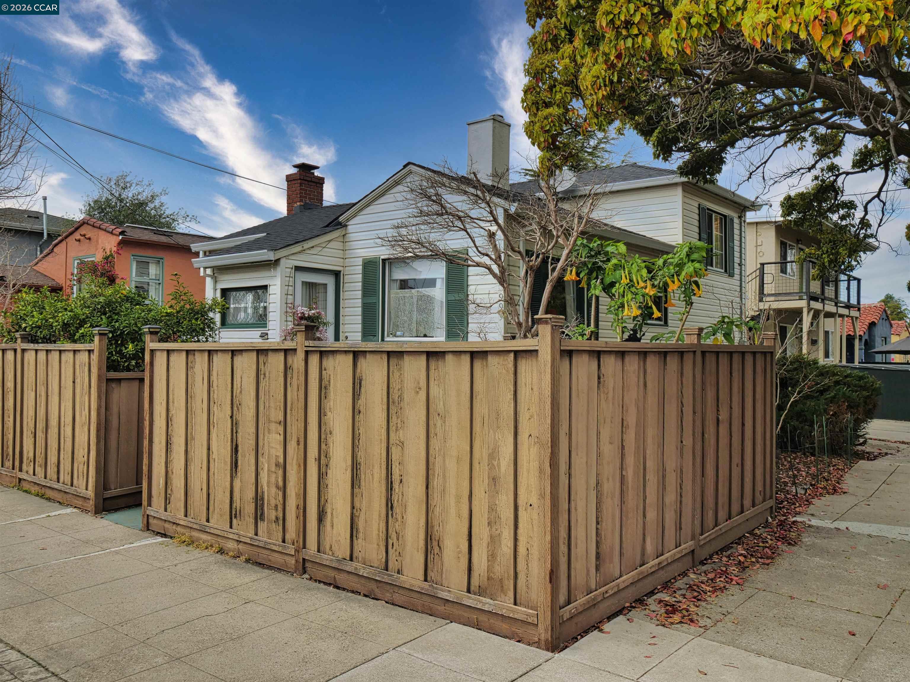 a front view of a house with wooden fence