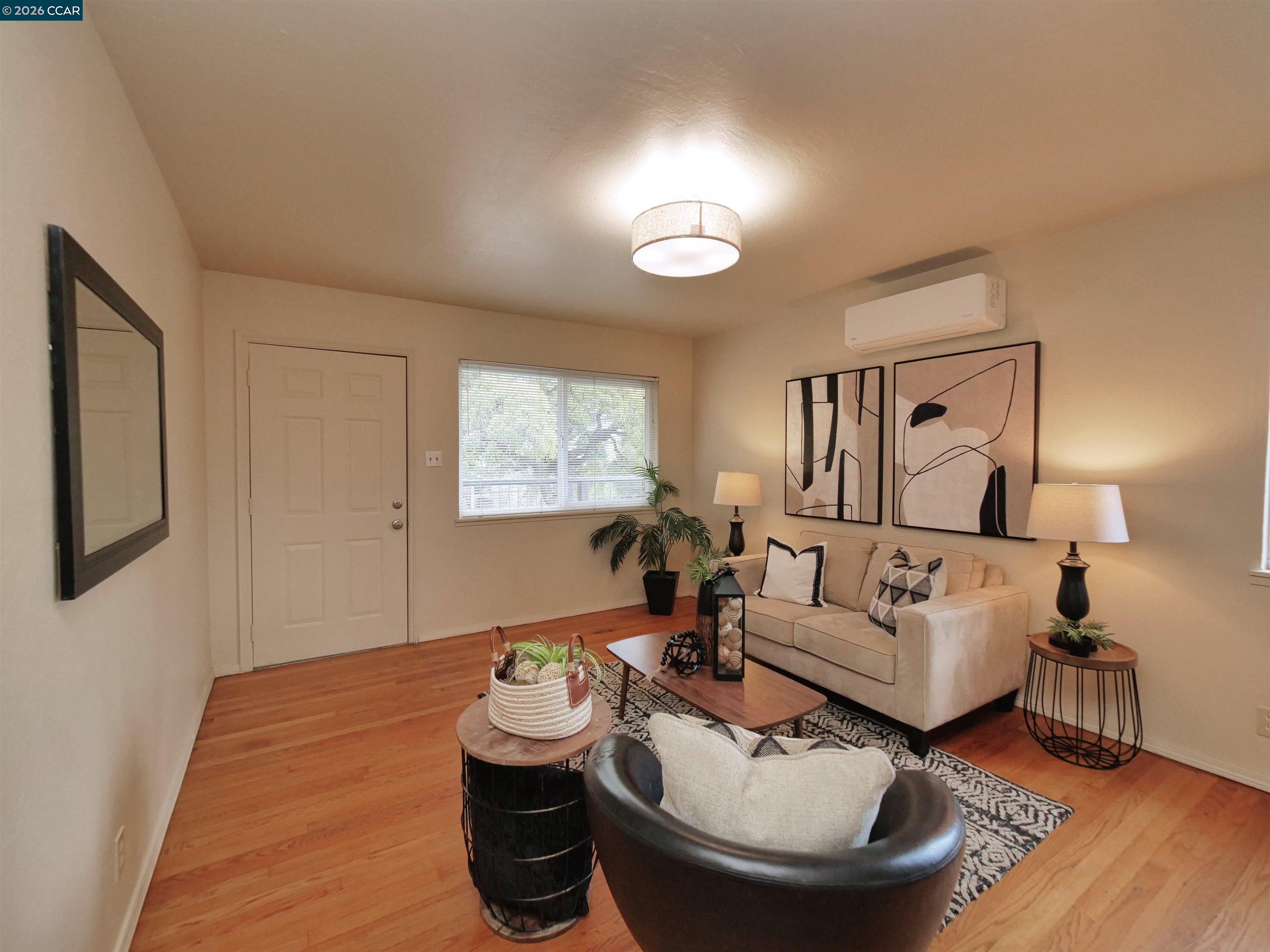 995 Virginia Street Berkeley, CA 94710 - Photo 18 of 59 a living room with furniture and a wooden floor