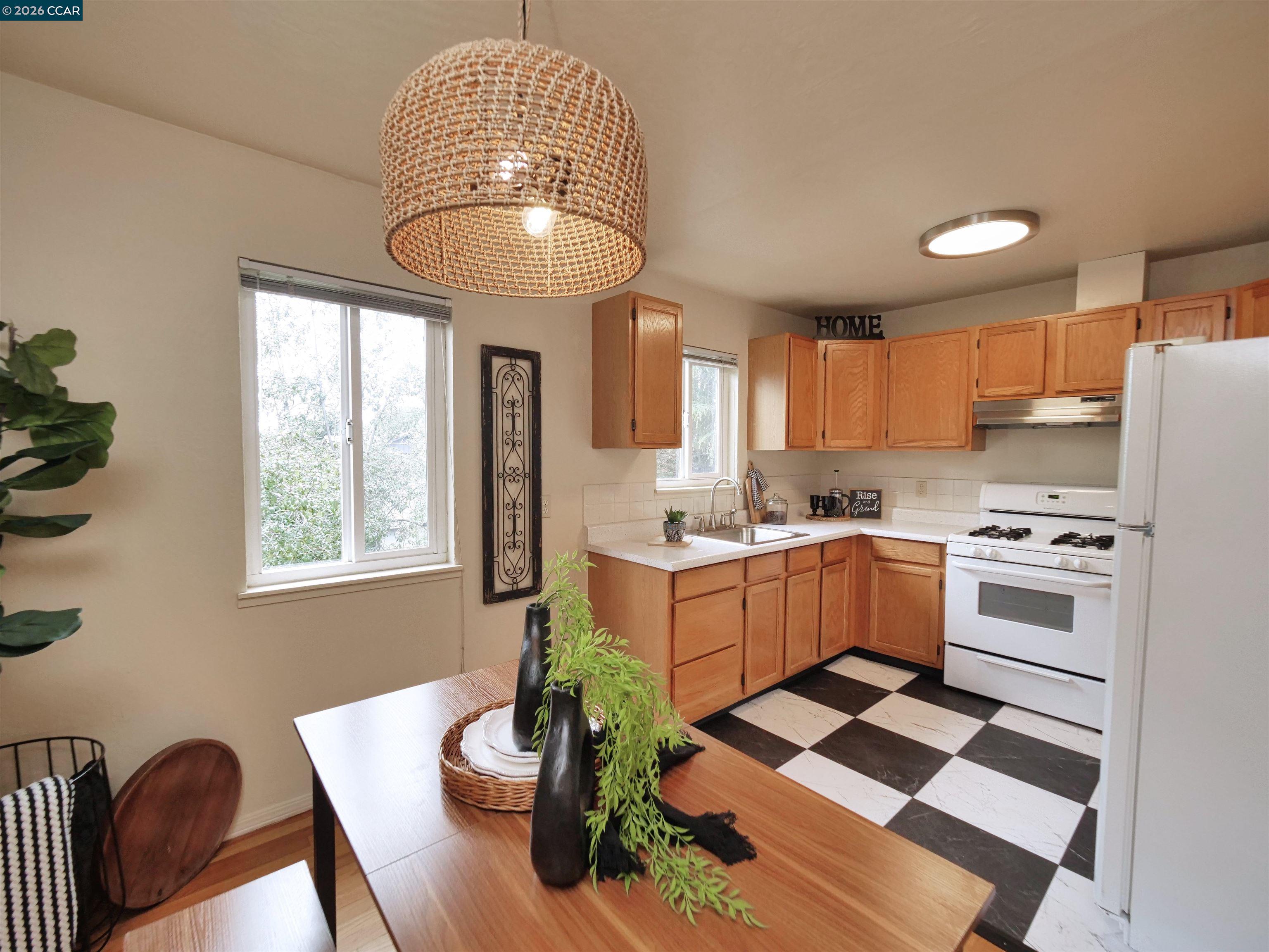 995 Virginia Street Berkeley, CA 94710 - Photo 22 of 59 a kitchen with stainless steel appliances kitchen island granite countertop a stove a sink and a chandelier