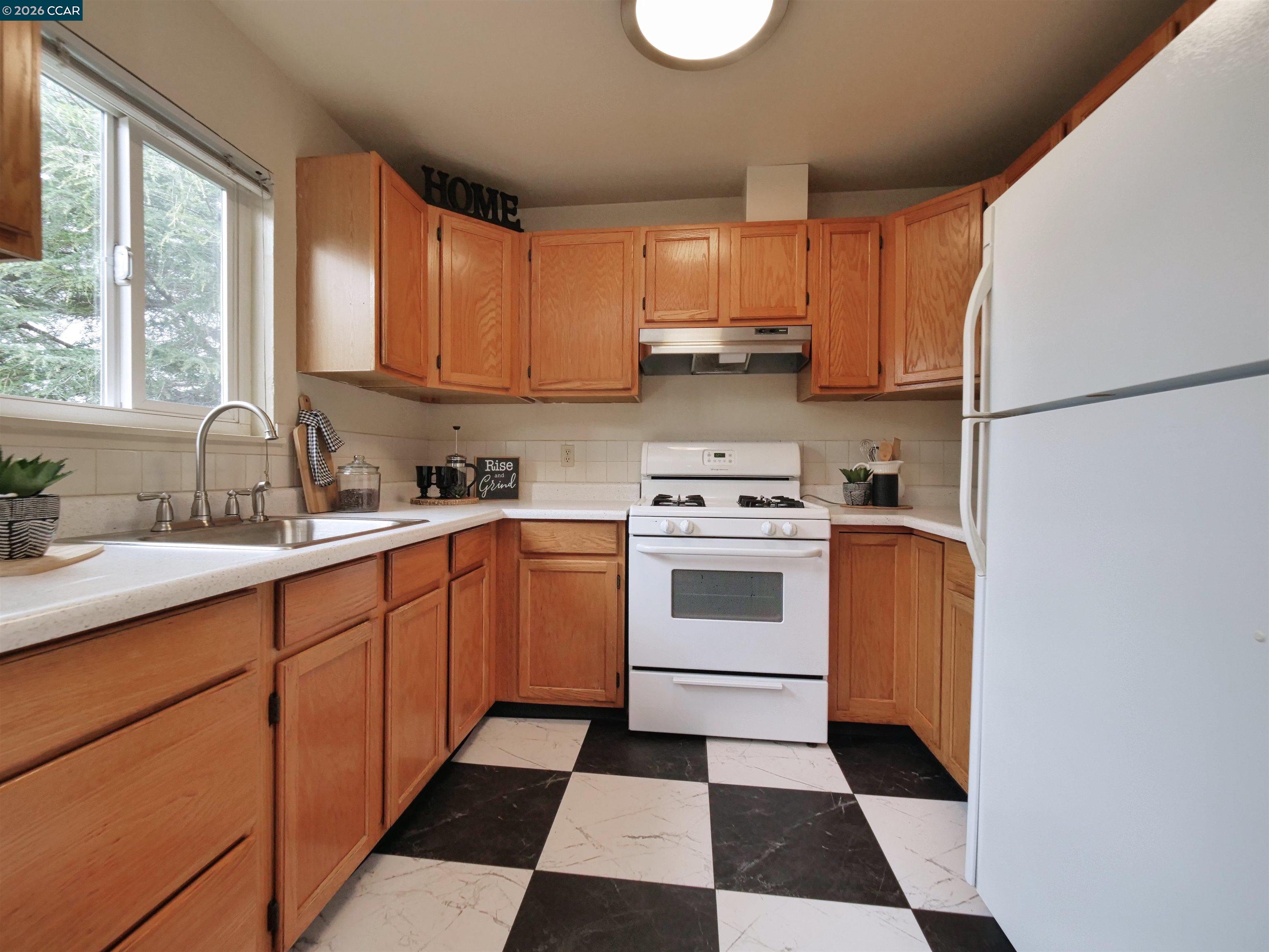 995 Virginia Street Berkeley, CA 94710 - Photo 23 of 59 a kitchen with stainless steel appliances a stove a sink and a window