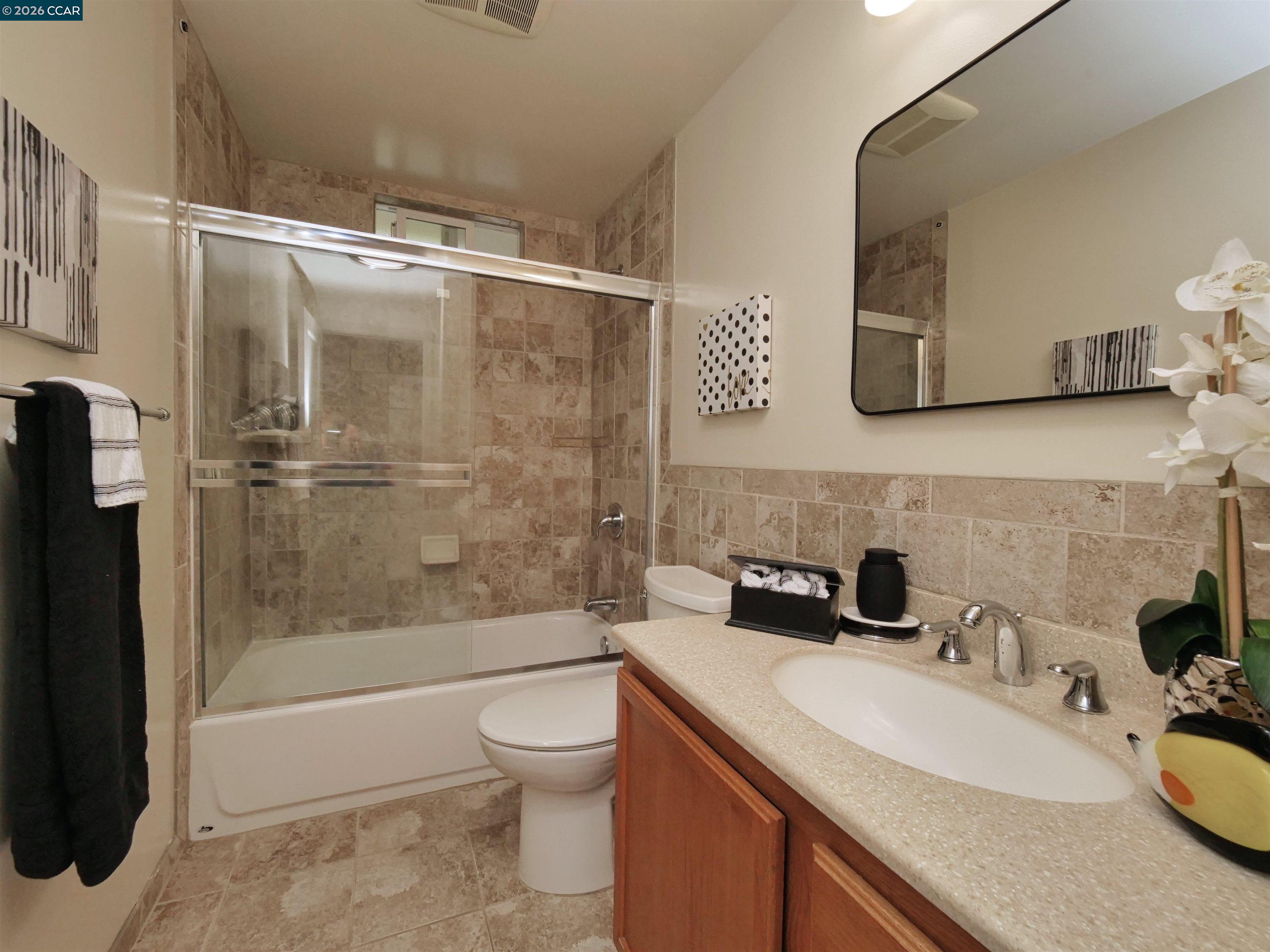 995 Virginia Street Berkeley, CA 94710 - Photo 27 of 59 a bathroom with a sink a toilet and shower