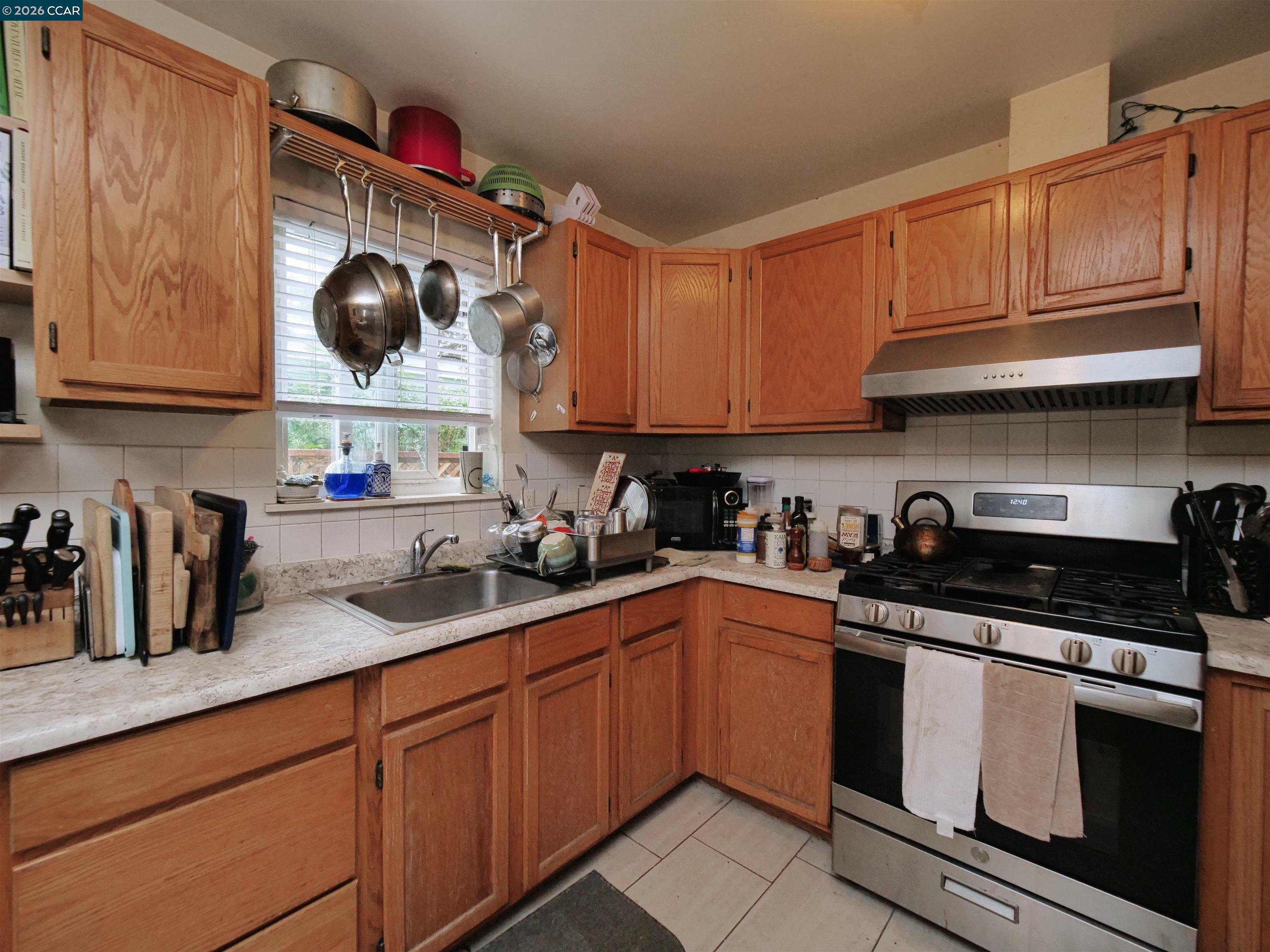 995 Virginia Street Berkeley, CA 94710 - Photo 37 of 59 a kitchen with stainless steel appliances granite countertop a sink and a stove