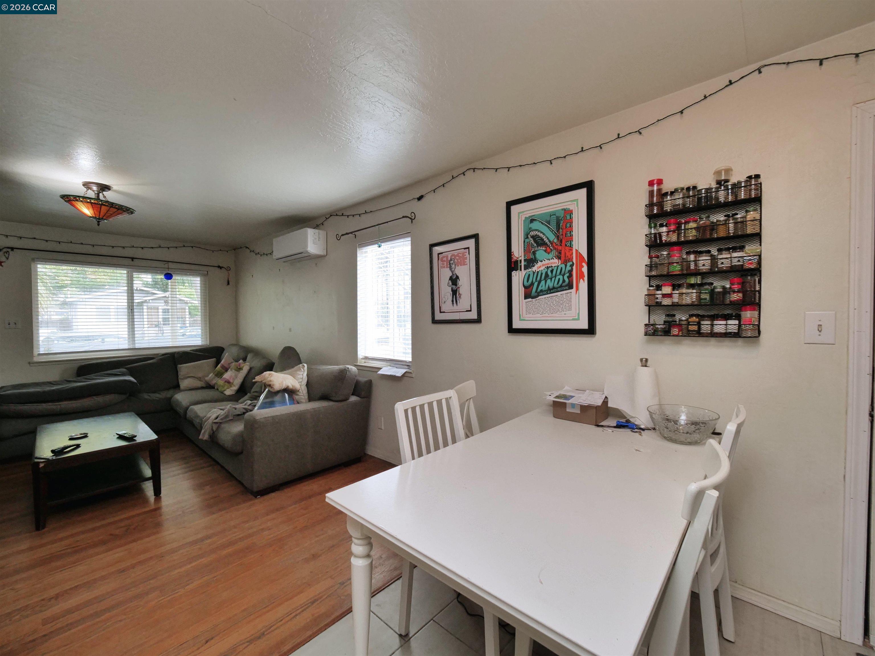 995 Virginia Street Berkeley, CA 94710 - Photo 38 of 59 a living room with furniture a window and a flat screen tv