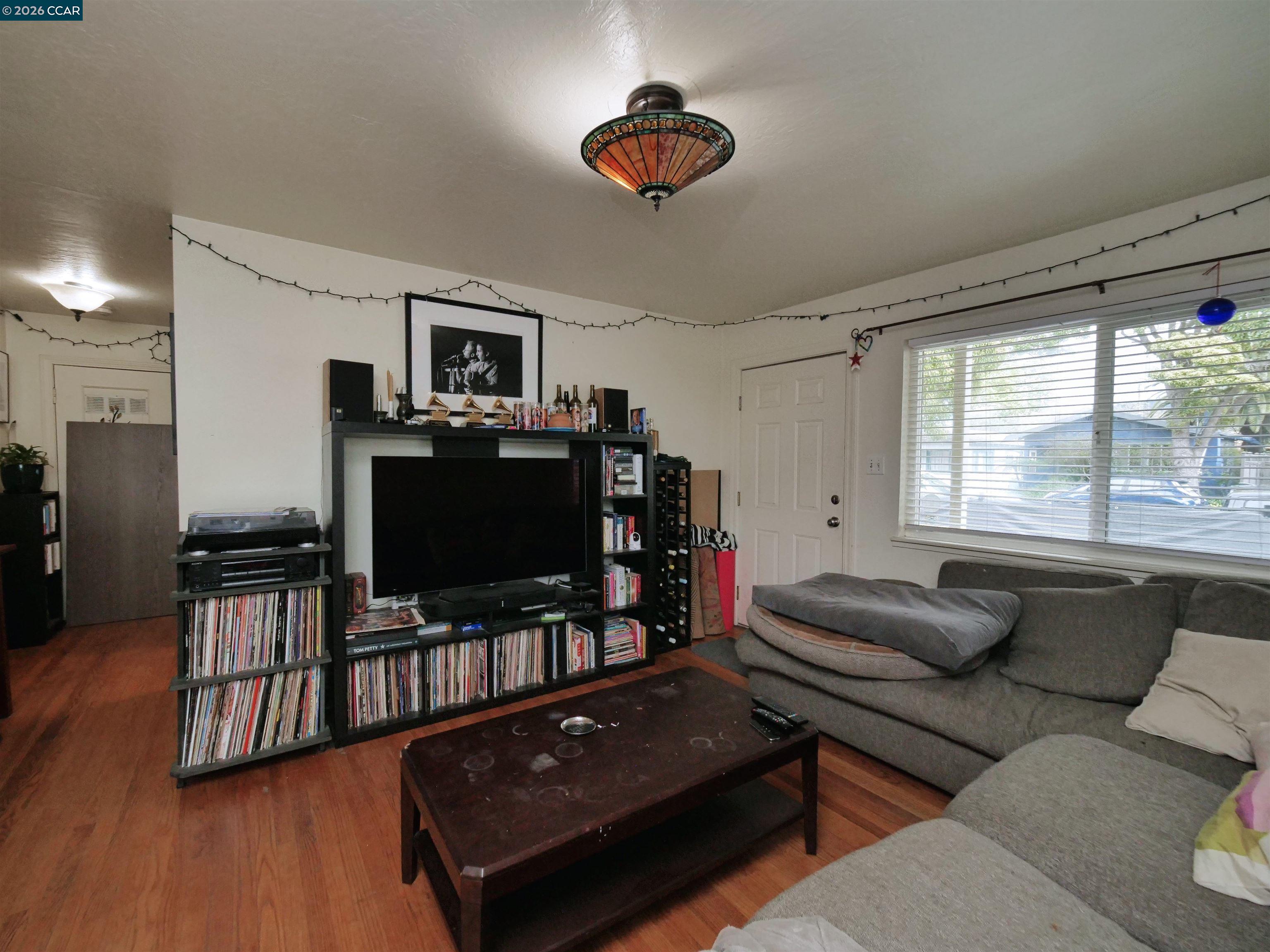 995 Virginia Street Berkeley, CA 94710 - Photo 39 of 59 a living room with furniture and a flat screen tv