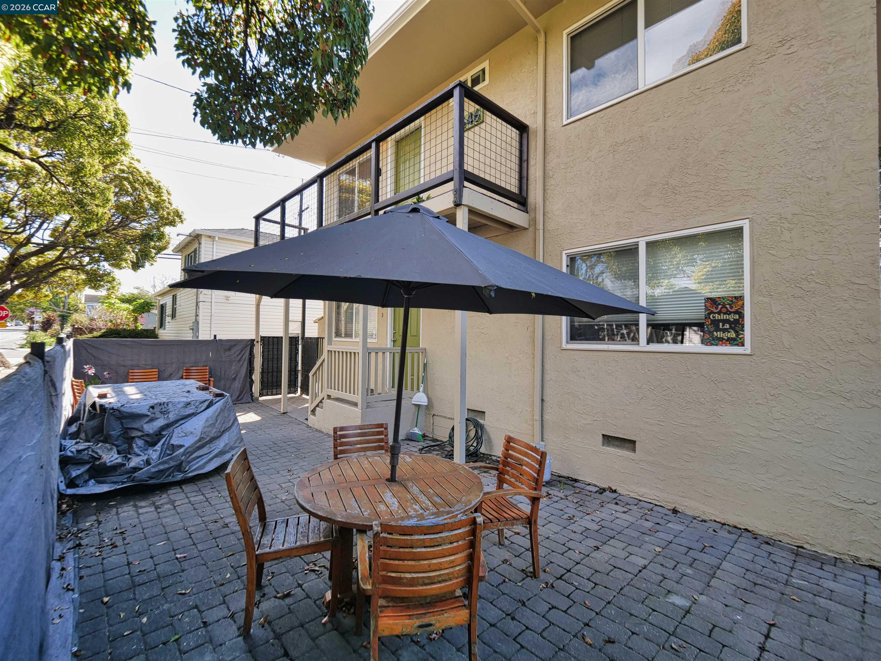 995 Virginia Street Berkeley, CA 94710 - Photo 43 of 59 a view of a patio with a table and chairs under an umbrella