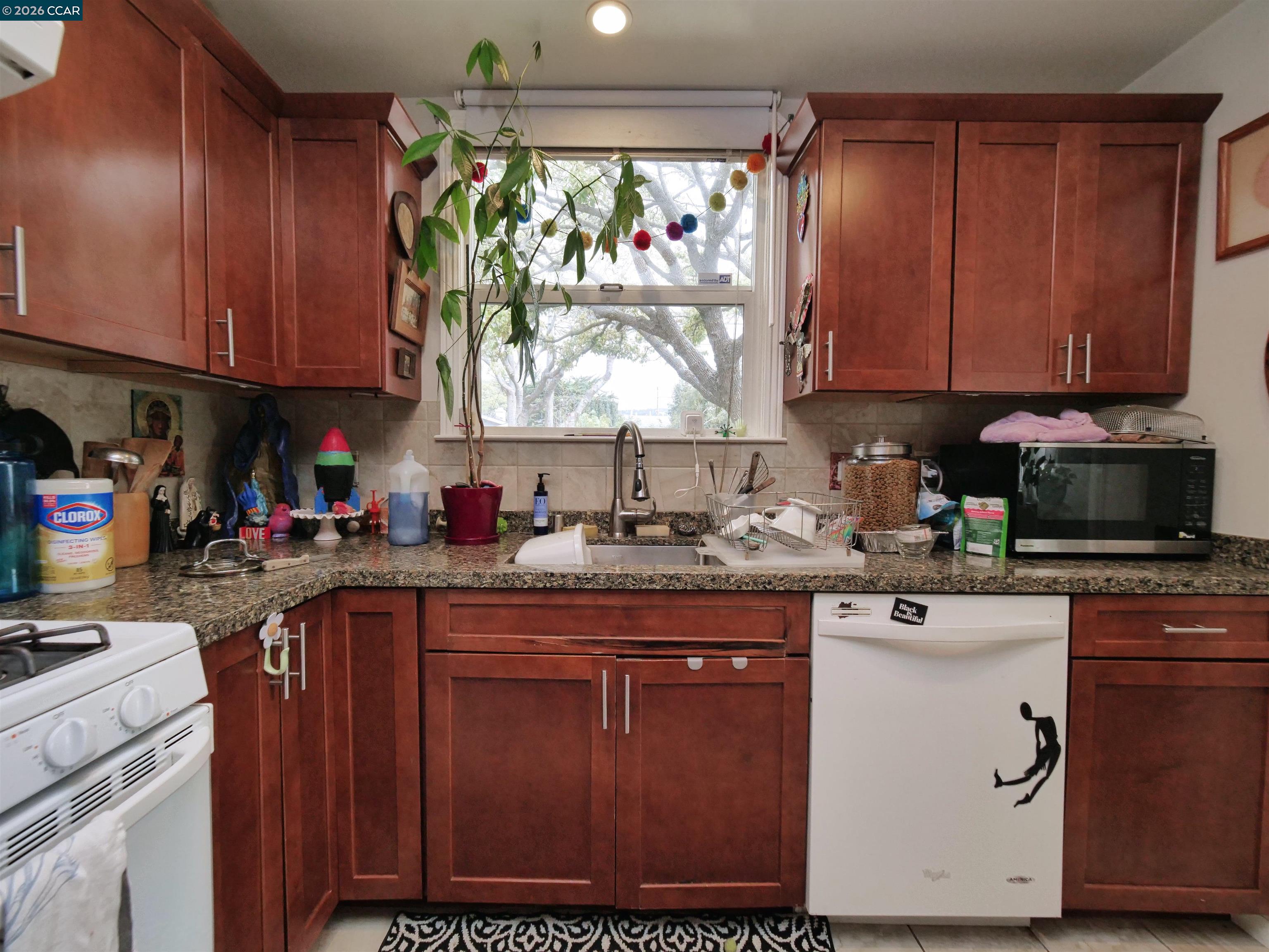 995 Virginia Street Berkeley, CA 94710 - Photo 49 of 59 a kitchen with a sink window and cabinets