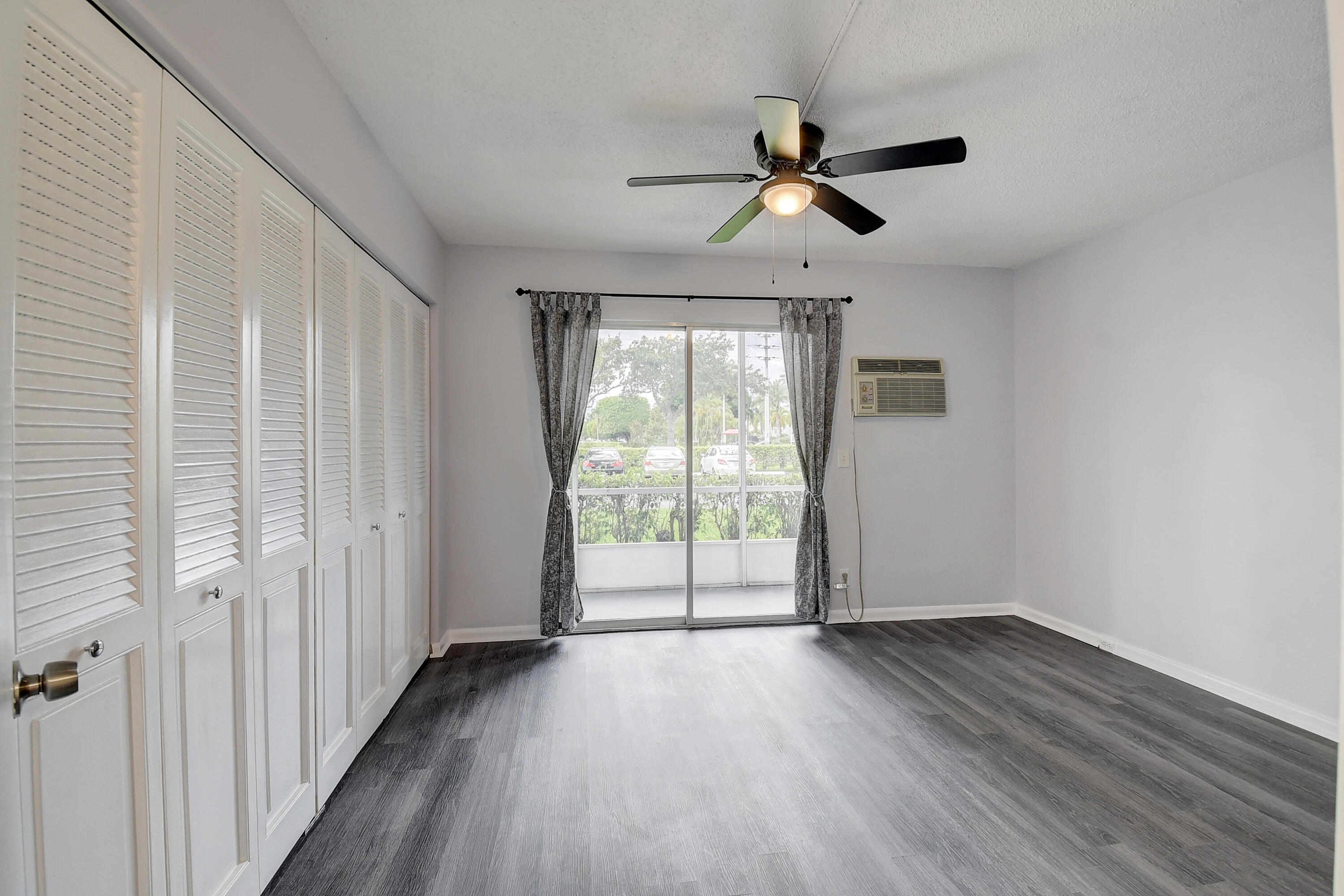 49 Suffolk B, Unit 49 Boca Raton, FL 33434 - Photo 12 of 47 wooden floor in an empty room with a window