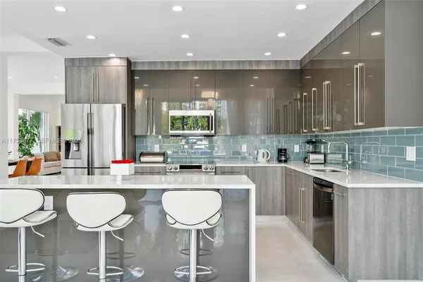 a large kitchen with a table and chairs in it