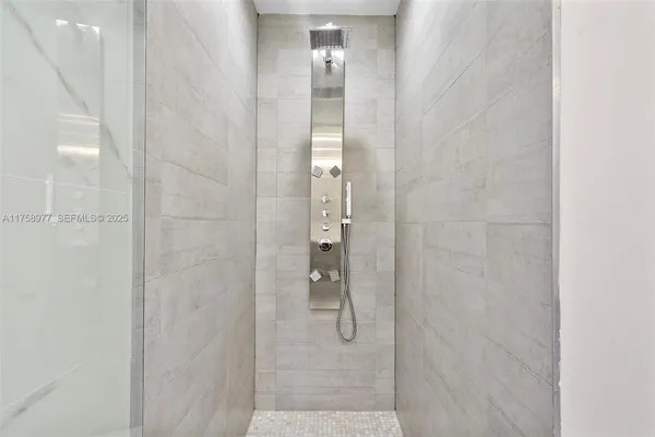 a bedroom with a large bed and a large window