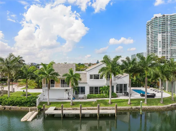 an aerial view of a house with a garden and lake view