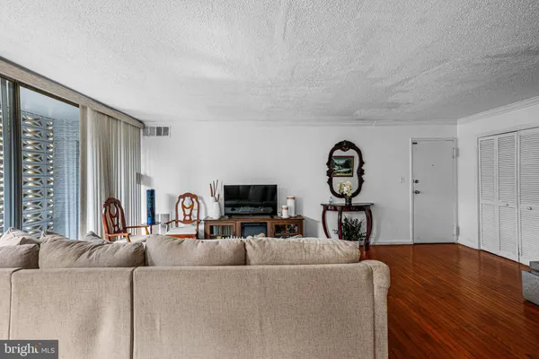 a living room with furniture a fireplace and a flat tv screen