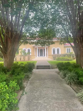 a front view of a house with garden