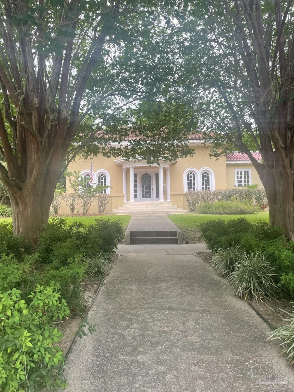 1904 East La Rua Street Pensacola, FL 32501 - Photo 1 of 14 a front view of a house with garden