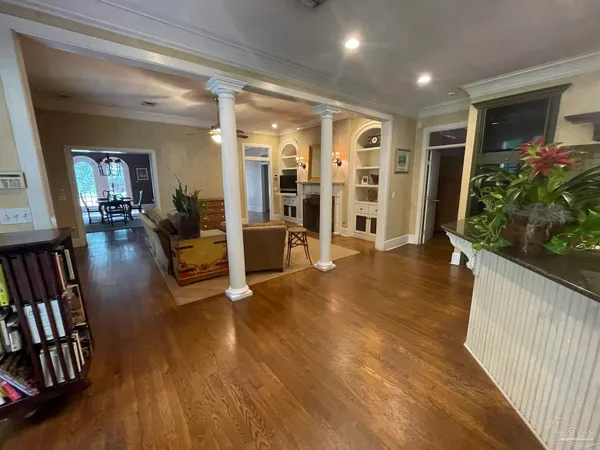 a living room with furniture and wooden floor