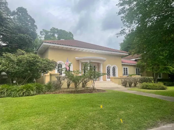 a front view of a house with garden