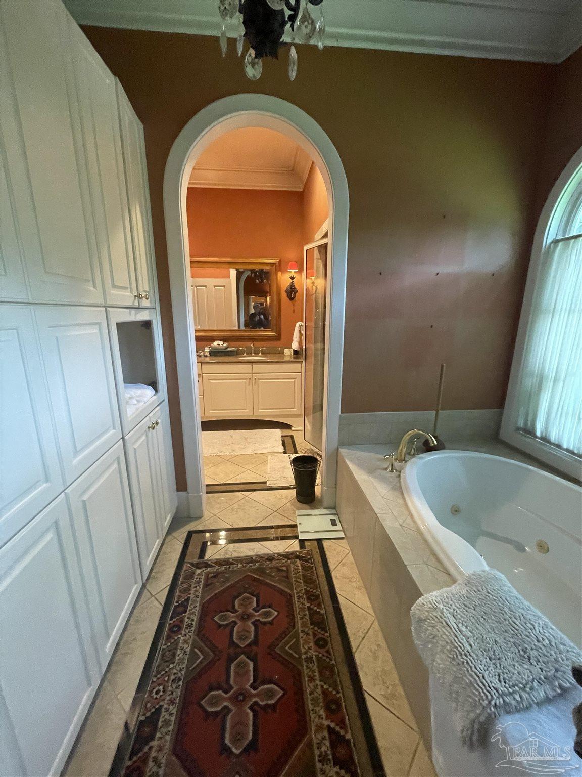 1904 East La Rua Street Pensacola, FL 32501 - Photo 5 of 14 a bathroom with a tub sink and mirror