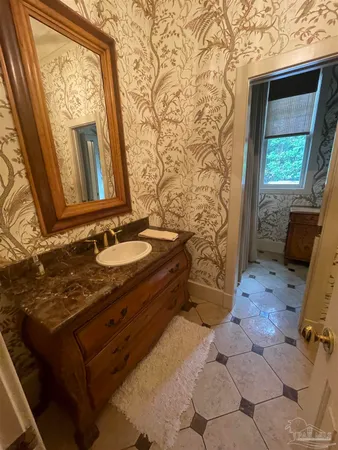 a bathroom with a sink a vanity and a mirror