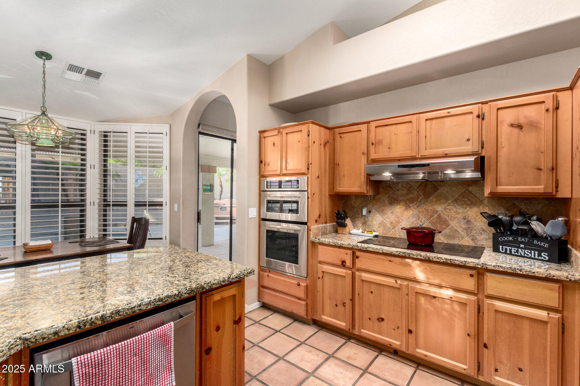 14044 South 33rd Way Phoenix, AZ 85044 - Photo 11 of 59 a kitchen with stainless steel appliances granite countertop a stove a sink and a microwave