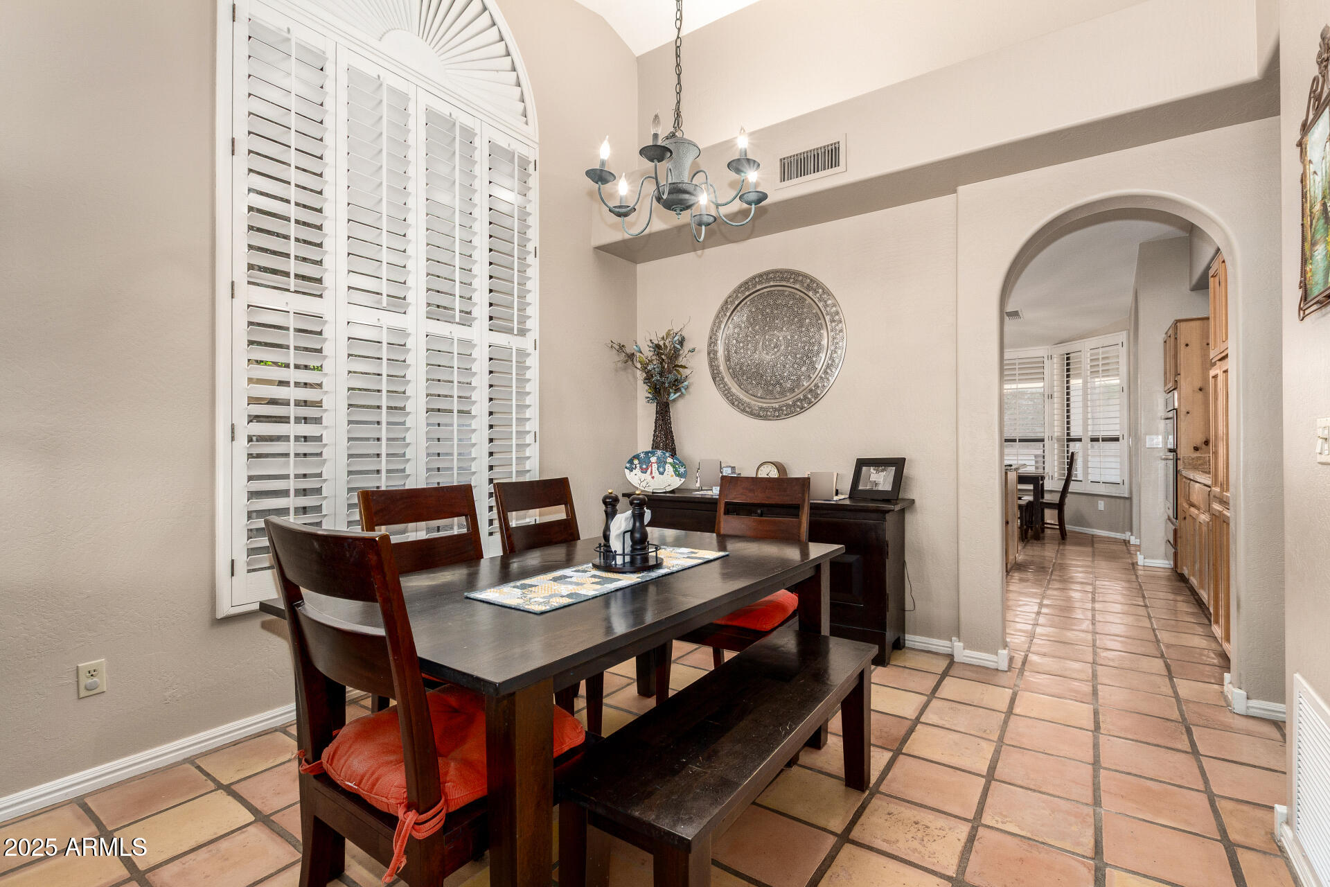 14044 South 33rd Way Phoenix, AZ 85044 - Photo 8 of 59 a view of a dining room with furniture and a chandelier