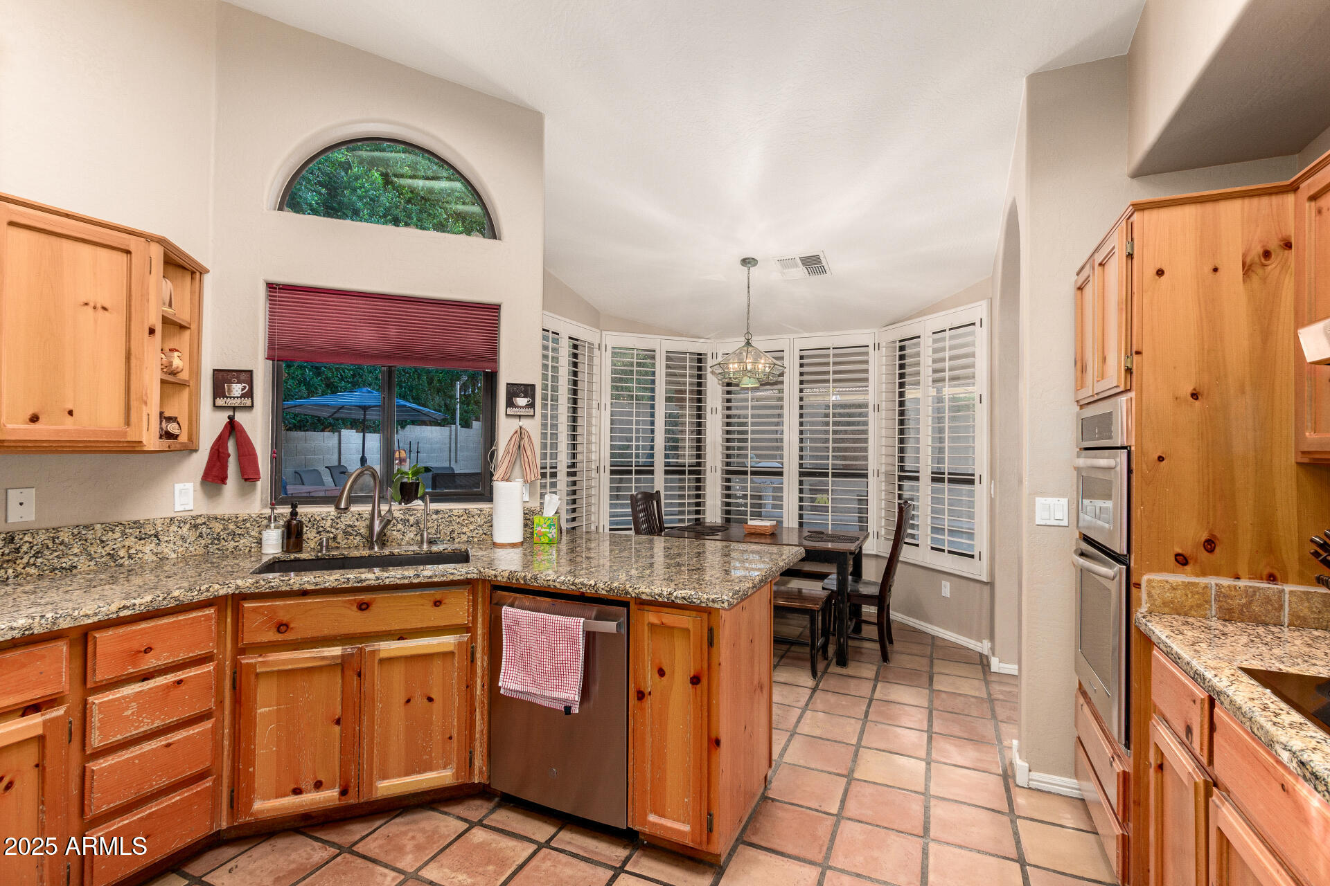 14044 South 33rd Way Phoenix, AZ 85044 - Photo 9 of 59 a kitchen with stainless steel appliances granite countertop a stove a sink and a refrigerator
