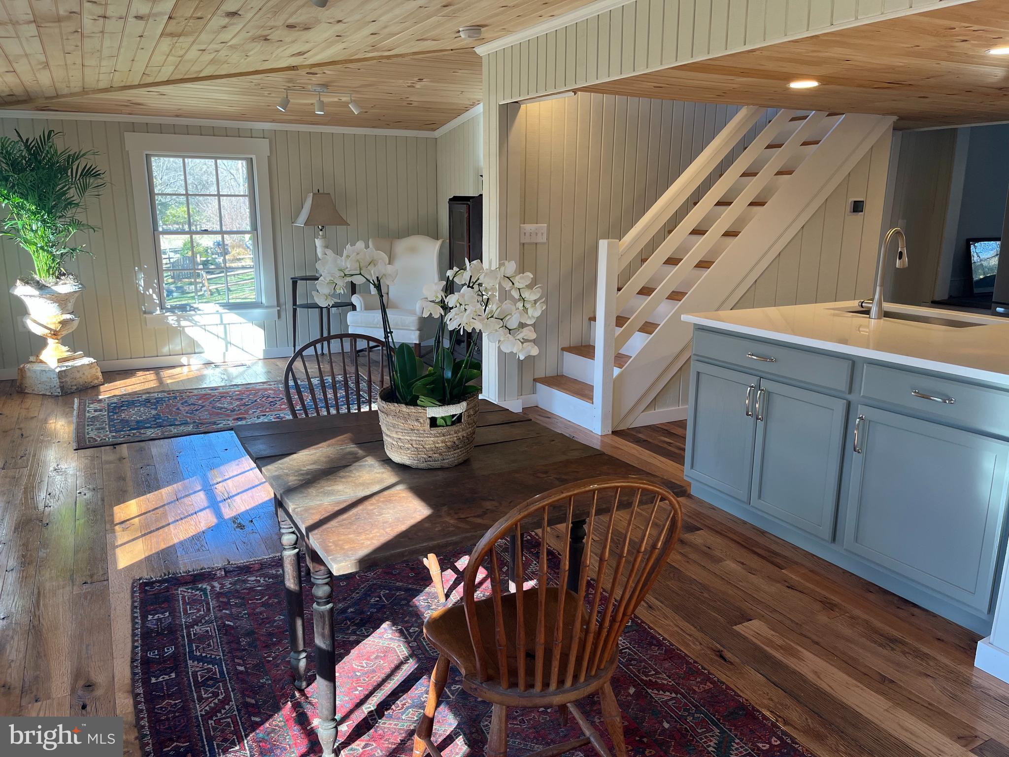 1690 Millwood Road Boyce, VA 22620 - Photo 18 of 44 a view of a dining room and livingroom with furniture wooden floor windows and a chandelier