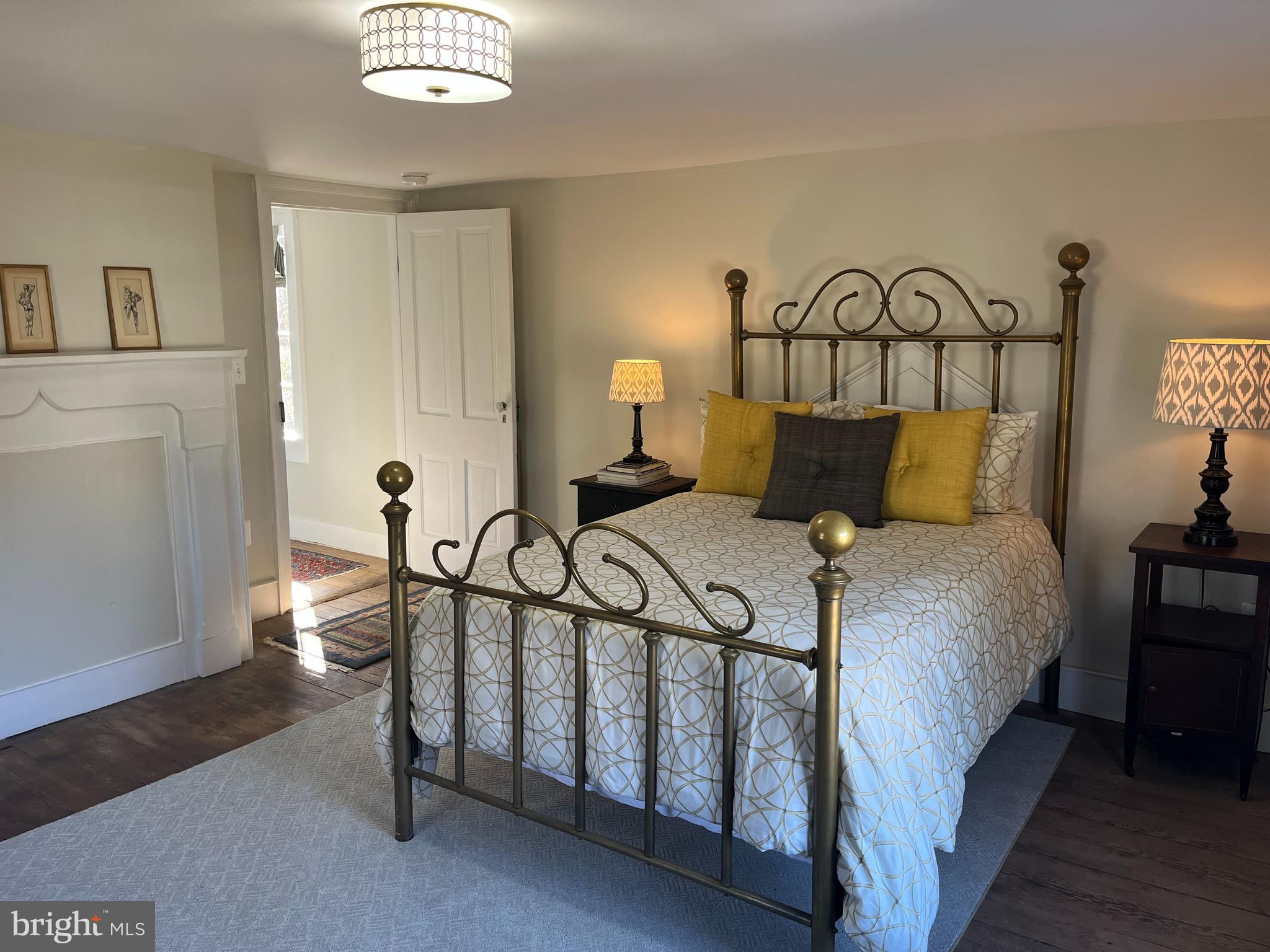 1690 Millwood Road Boyce, VA 22620 - Photo 28 of 44 a bedroom with a bed and a lamp with the table