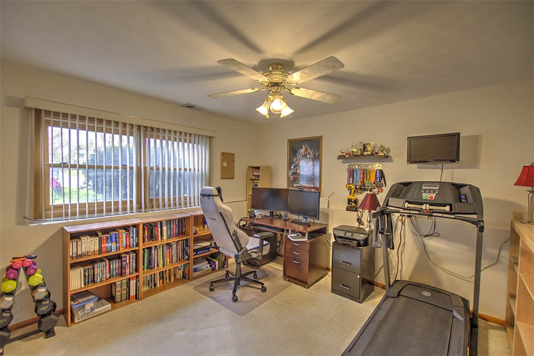 4081 Sheffield Court Decatur, IL 62526 - Photo 16 of 29 a view of a workspace with furniture and a bookshelf
