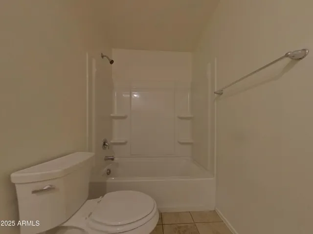 a bathroom with a toilet and shower