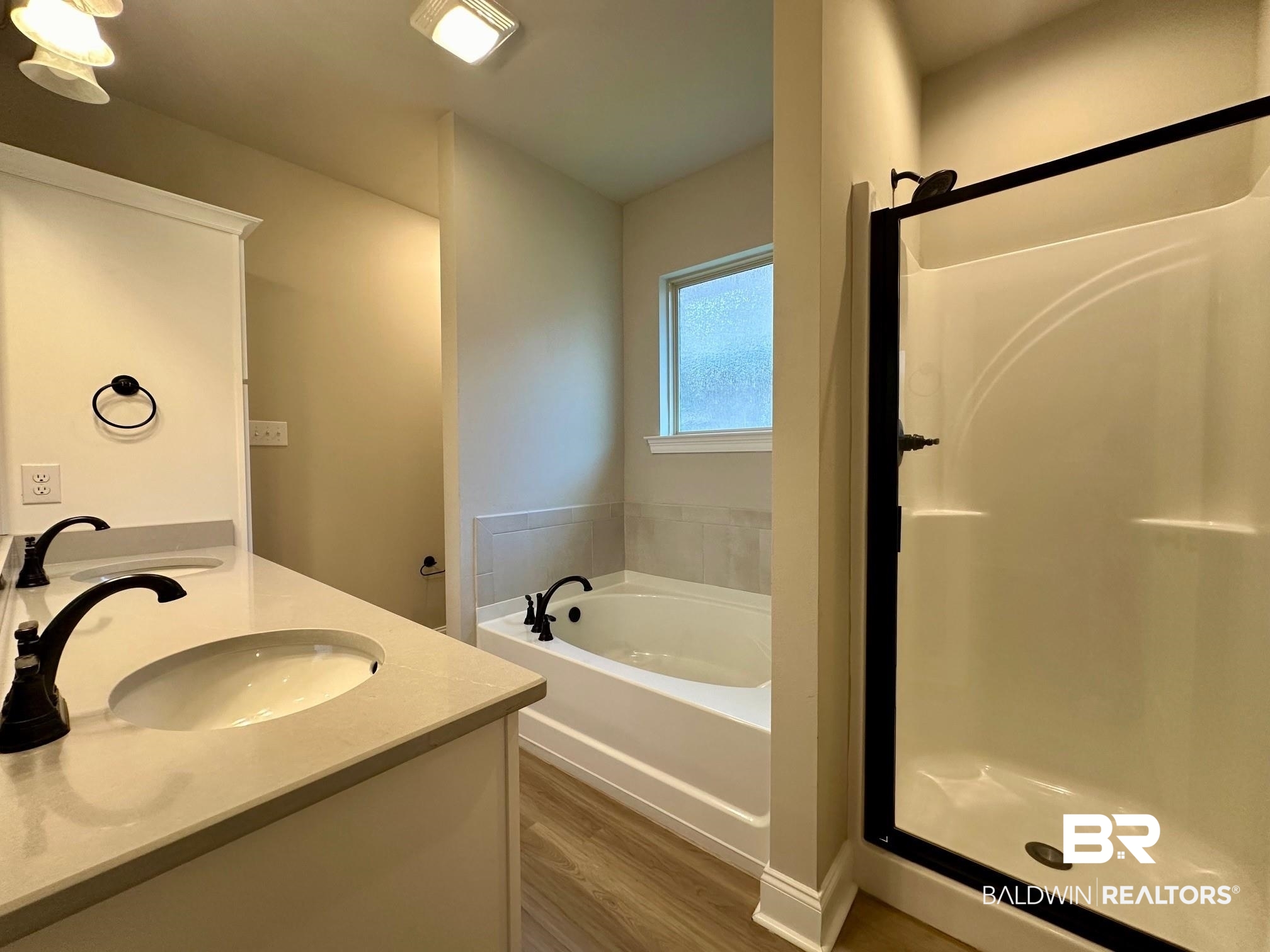 1009 Ruisseau Drive Foley, AL 36535 - Photo 41 of 55 Bathroom featuring vanity, shower with separate bathtub, and hardwood / wood-style flooring