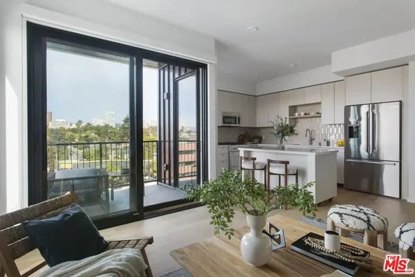 a living room with furniture and a floor to ceiling window