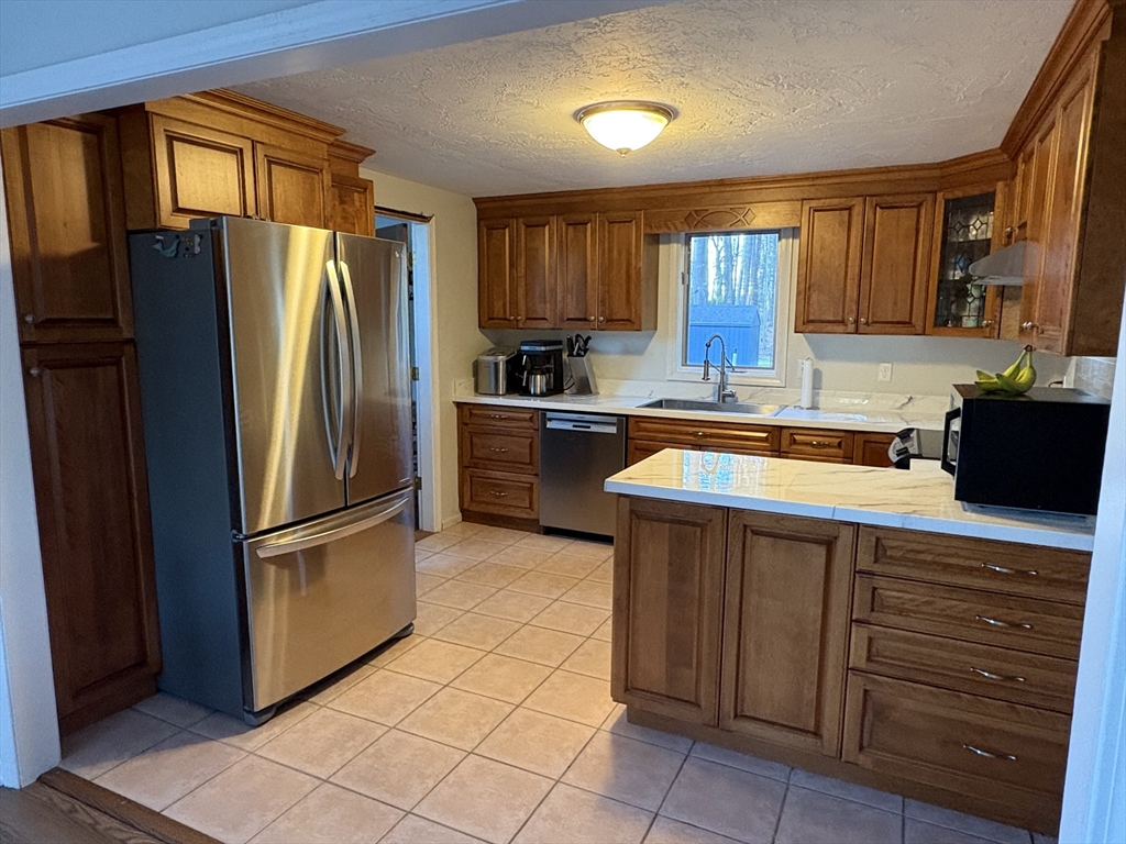 11 Potter Road Douglas, MA 01516 - Photo 14 of 41 a kitchen with stainless steel appliances granite countertop a refrigerator and a sink