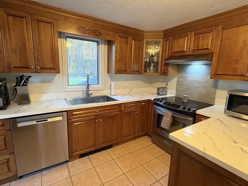 11 Potter Road Douglas, MA 01516 - Photo 15 of 41 a kitchen with cabinets and appliances