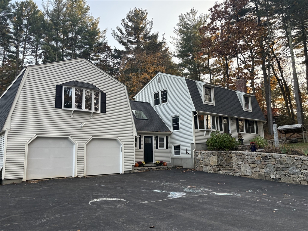 11 Potter Road Douglas, MA 01516 - Photo 2 of 41 a front view of a house with a garden and garage