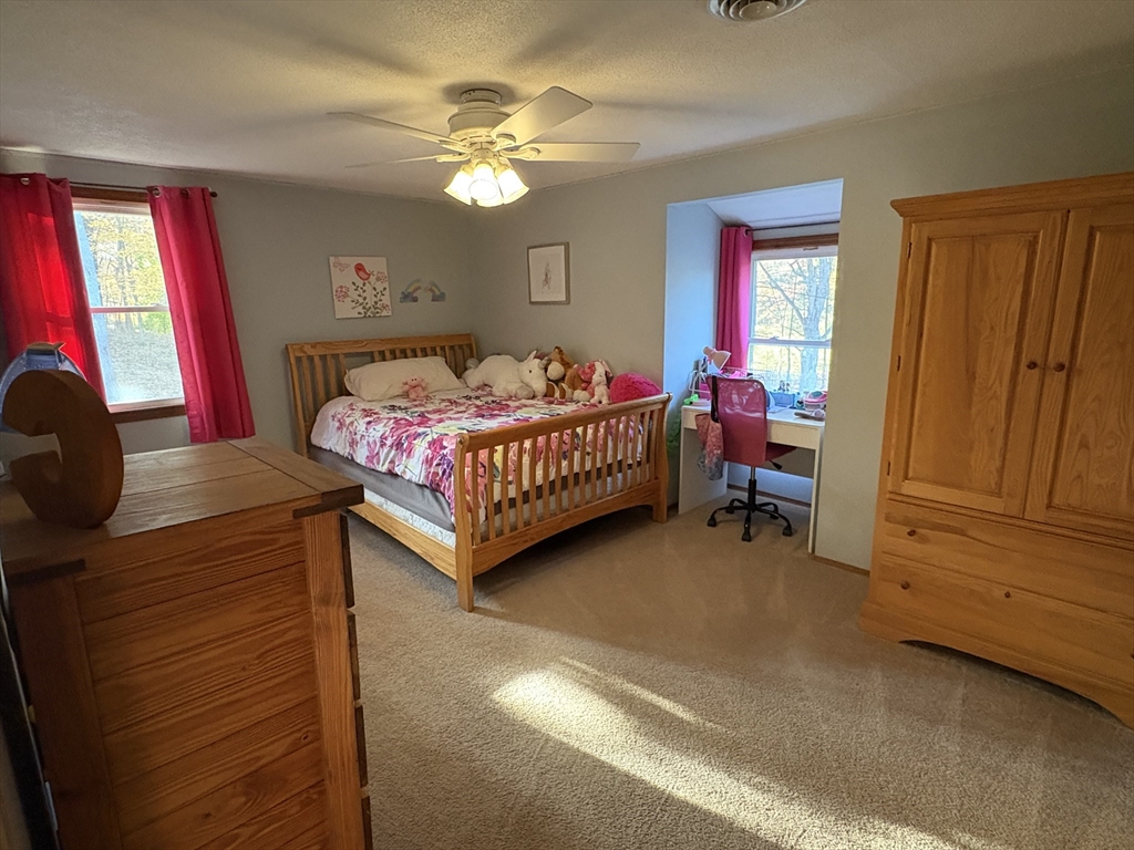 11 Potter Road Douglas, MA 01516 - Photo 27 of 41 a bedroom with a bed and a chandelier