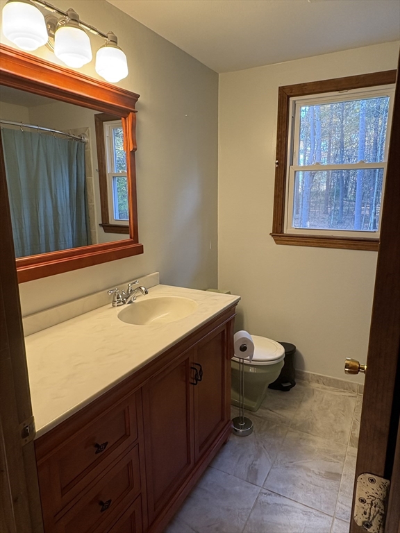 11 Potter Road Douglas, MA 01516 - Photo 28 of 41 a bathroom with a sink a toilet and mirror