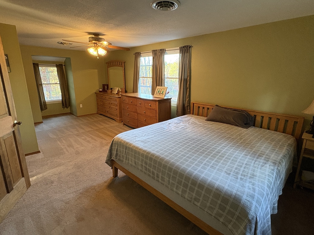 11 Potter Road Douglas, MA 01516 - Photo 30 of 41 a spacious bedroom with a bed and a mirror