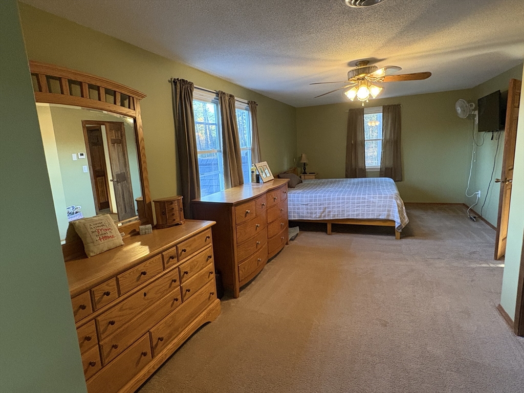 11 Potter Road Douglas, MA 01516 - Photo 31 of 41 a spacious bedroom with a bed and a dresser in it