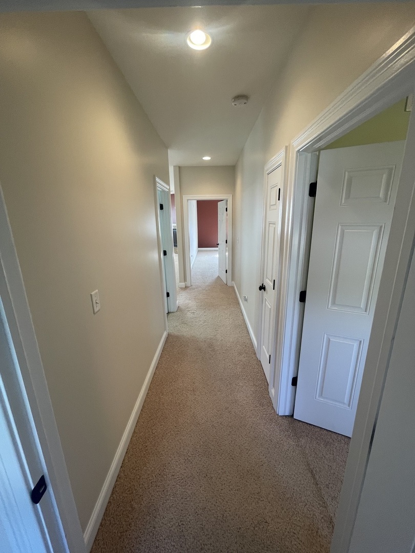 440 Edgebrook Drive Bourbonnais, IL 60914 - Photo 24 of 34 a view of a hallway with wooden floor and a bathroom