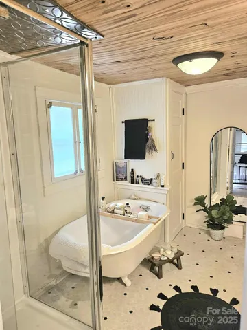 a bathroom with a tub sink and mirror
