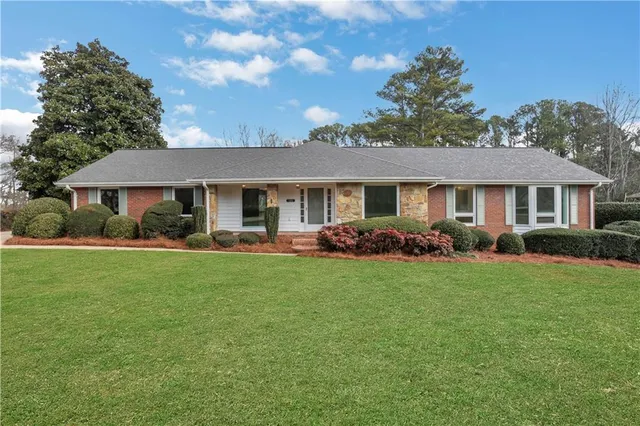 a front view of house with yard and green space