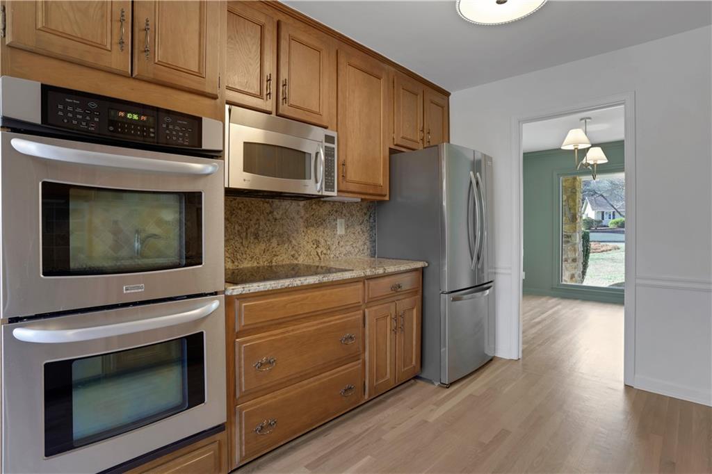 600 Rounsaville Road Roswell, GA 30076 - Photo 15 of 45 a kitchen with stainless steel appliances granite countertop a stove microwave and refrigerator