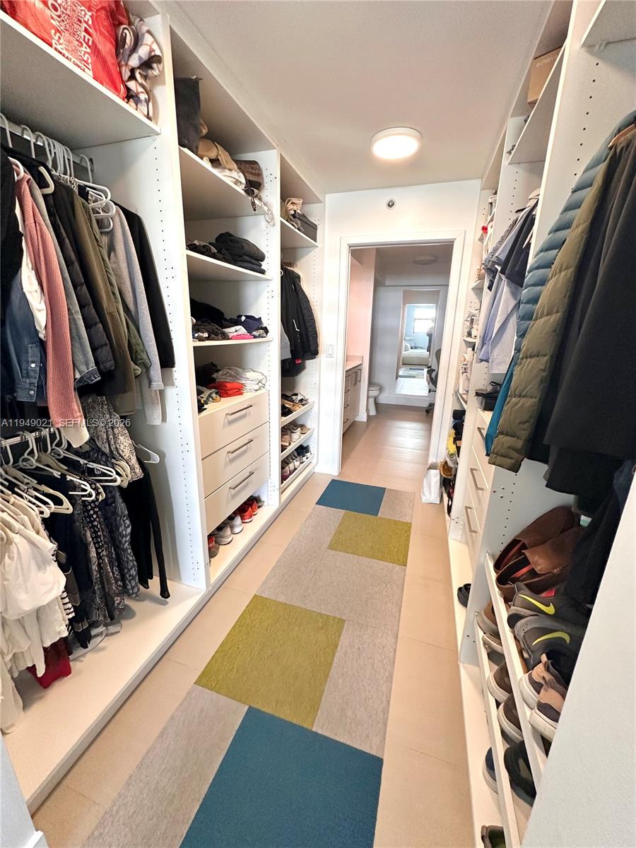 170 Ocean Ln Drive, Unit 809 Key Biscayne, FL 33149 - Photo 18 of 31 a view of walk in closet with clothes and shoes
