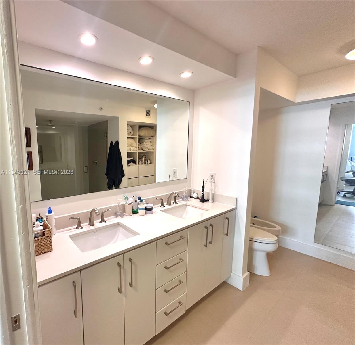 170 Ocean Ln Drive, Unit 809 Key Biscayne, FL 33149 - Photo 19 of 31 a bathroom with a double vanity sink and a toilet