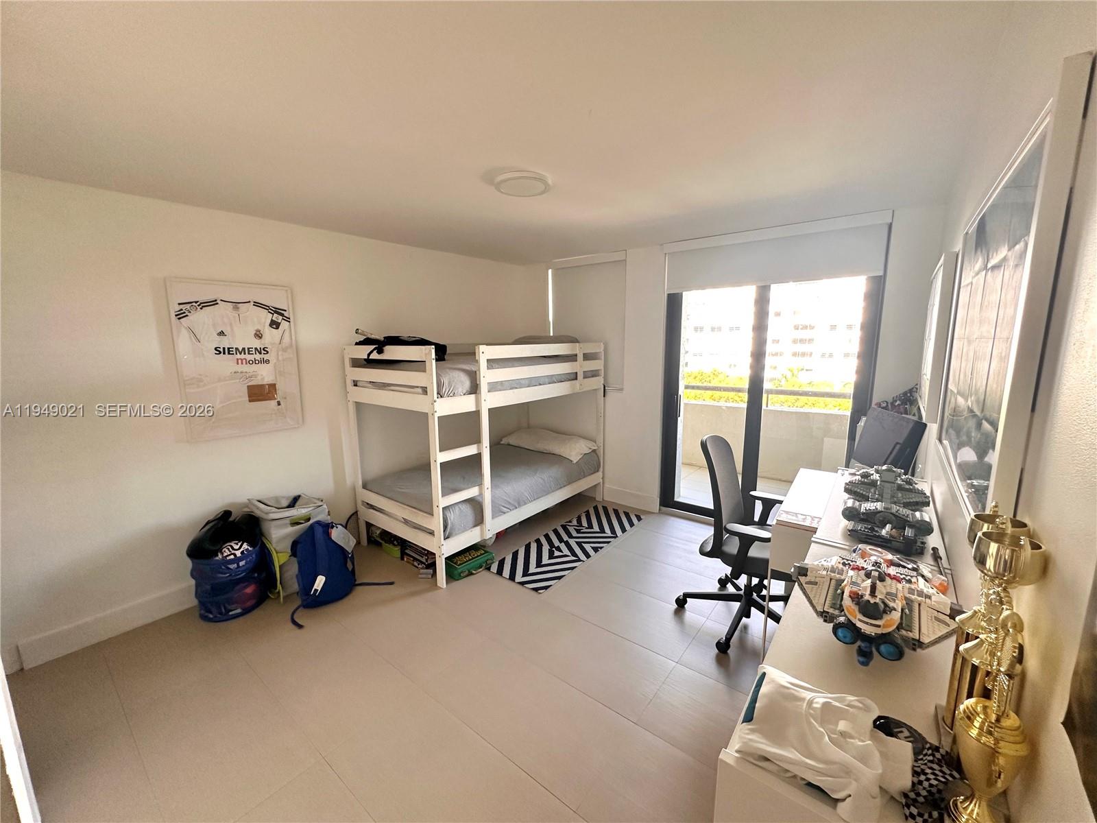 170 Ocean Ln Drive, Unit 809 Key Biscayne, FL 33149 - Photo 24 of 31 a room with gym equipment and a large window