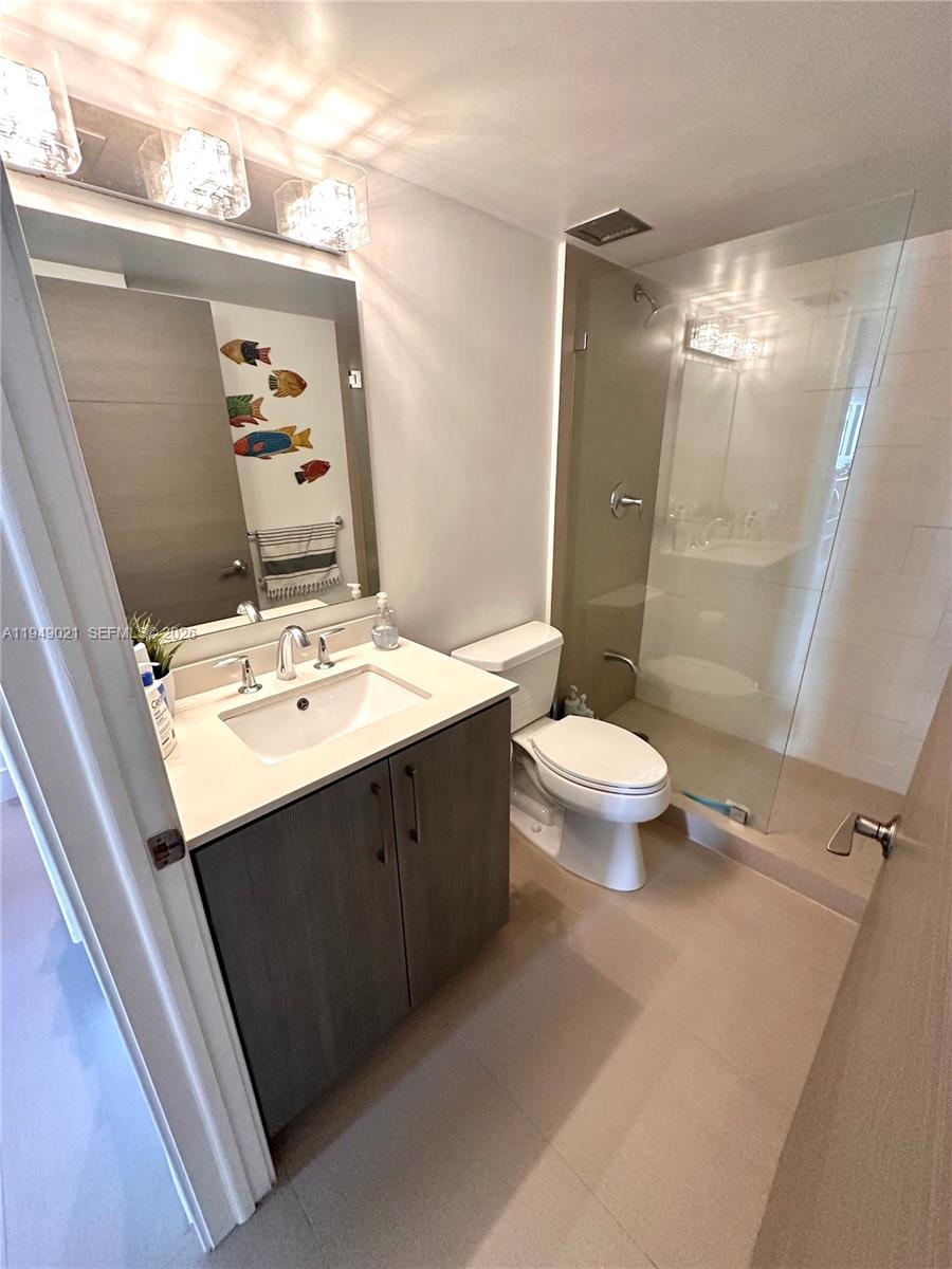 170 Ocean Ln Drive, Unit 809 Key Biscayne, FL 33149 - Photo 25 of 31 a bathroom with a sink vanity mirror and toilet